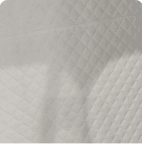 Close-up of warm cream quilted leather interior lining with diamond stitching