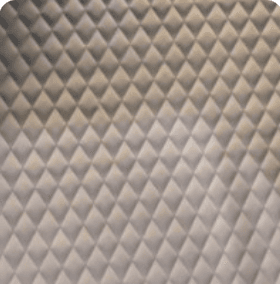 Close-up of soft light gray quilted leather interior lining with diamond stitching