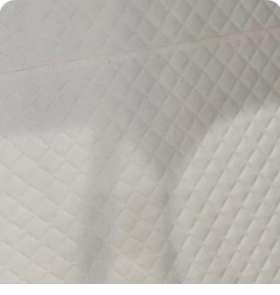 Close-up of warm cream quilted leather interior lining with diamond stitching