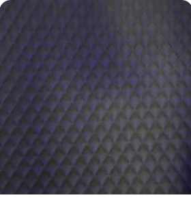 Close-up of rich charcoal dark gray quilted leather interior lining with diamond stitching