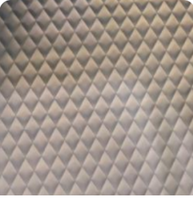 Close-up of soft light gray quilted leather interior lining with diamond stitching